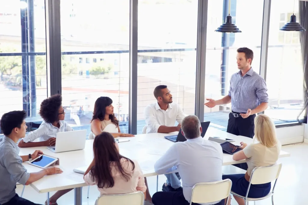 a group of people holding a meeting in a Houston temp agency room.