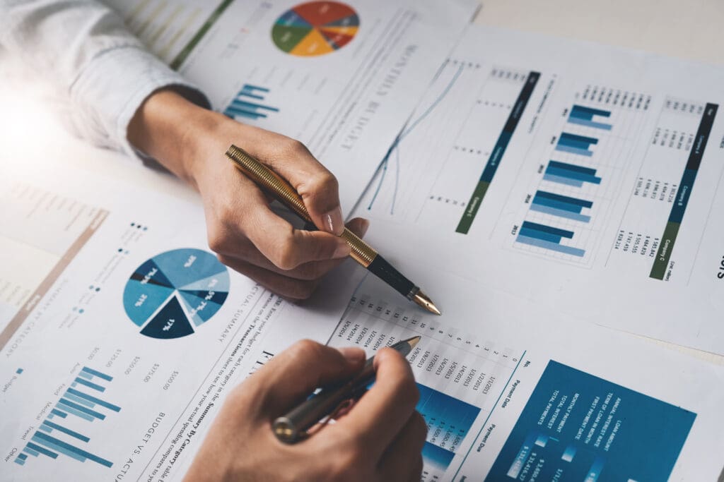 Close up of people meeting to discuss financial statistics for their accounting recruiting firms.